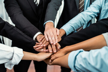Multiracial business people make synergy hand stack together in meeting room as cooperation or team...