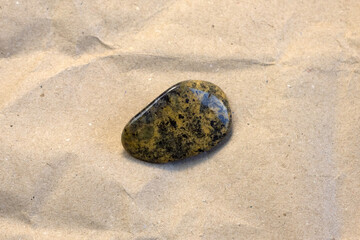 Obraz premium Red and multicolored jasper polished tumblestones as nice natural background on white plate