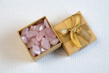 Several pieces of polished pink quartz on textured background. Minimal color still life photography