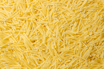 Uncooked Filini Pasta: A Culinary Canvas of Noodles, Creating a Lively and Textured Background for Gourmet Cooking. Dry Pasta. Raw Macaroni - Top View, Flat Lay