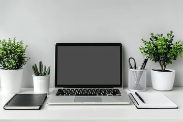 Fototapeta premium A clean work desk setup with a laptop, notepad, and pen holder isolated on a white background