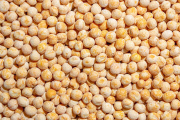 Uncooked Yellow Polished Peas Background. A Culinary Canvas of Dry Yellow Peas, Creating a Lively and Textured Background for Gourmet Cooking. Scattered Raw Polished Peas. Healthy Eating Ingredients