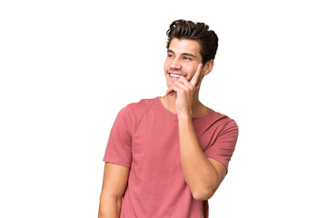 Obraz premium Young handsome caucasian man over isolated background thinking an idea while looking up