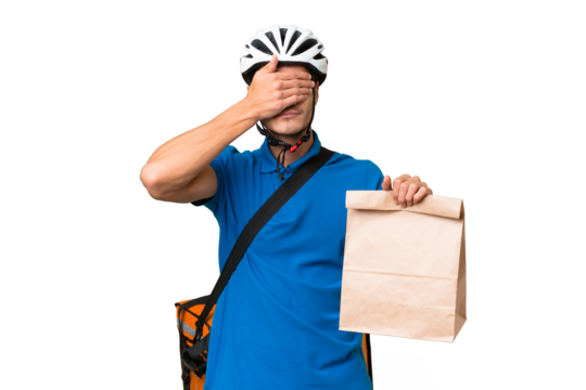 Young caucasian man taking a bag of takeaway food over isolated background covering eyes by hands. Do not want to see something