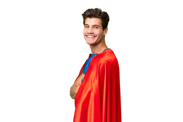 Super Hero caucasian man over isolated background with arms crossed and looking forward