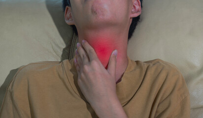 Close up ill young man touching sore throat feeling or dehydration with unhappy. suffering from...