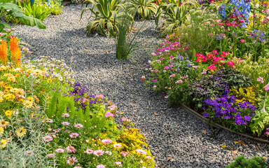 colorful flowers with rock path leading through a flower garden
