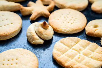 Homemade cookies of cheerful shapes made by a child on the protvina. A family hobby.