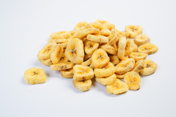 A pile of banana chips on a white background