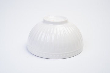 A white bowl with a white rim sits on a white background
