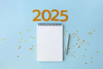 2025 New Year concept with empty notebook for your goals, plans, resolutions. Flat lay style....