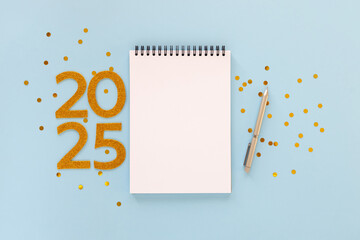 2025 New Year concept with empty notebook for your goals, plans, resolutions. Flat lay style....