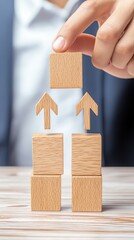 A hand places a wooden block atop a stack of blocks, symbolizing growth and progress in a business or personal development context.