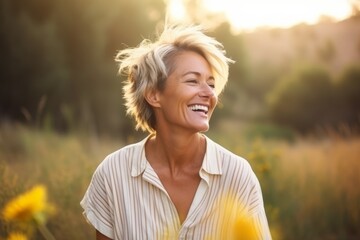 Portrait of a happy senior woman standing in field smiling at camera