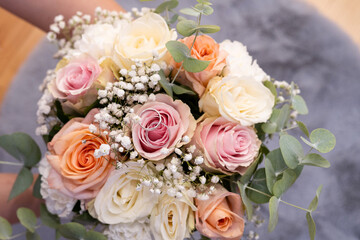 Wedding beautiful bouquet of roses in the hands of the bride, wedding rings