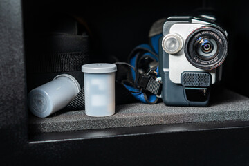 Vintage Camcorder and Film Canister in Metal Cabinet