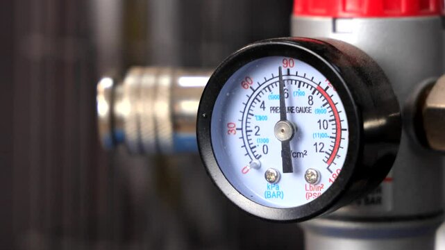Pressure Gauge on Compressor Showing Kilopascal Reading - Close-Up of Industrial Pressure Sensor Display