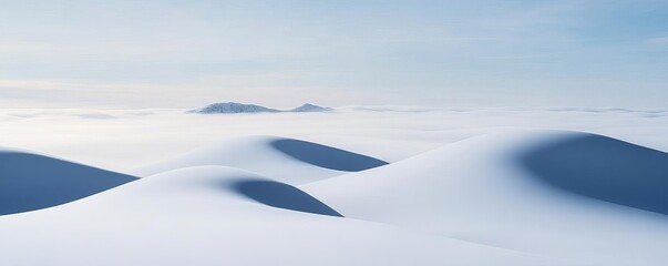 Snow-covered hills with fog rolling in, capturing winter s mystique