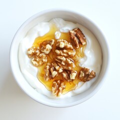 A bowl of yogurt topped with walnuts and drizzled with honey.