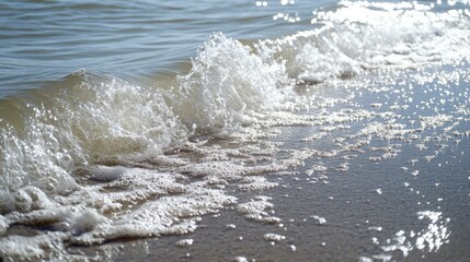Fototapeta premium Close-up of gentle sea waves lapping on a smooth water surface under bright sunlight.