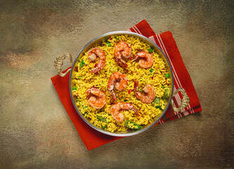 rice with saffron and shrimp, in a frying pan, paella with shrimp, top view, homemade, no people,
