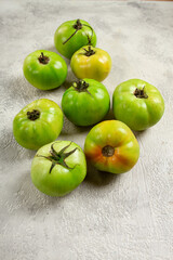 green tomatoes scattered on the table, unripe tomatoes, raw , selective focus, no people,