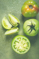 green tomatoes, sliced on the table, unripe tomatoes, raw , selective focus, no people,