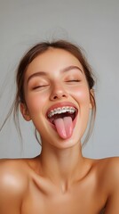 Woman with braces sticking out her tongue for oral health check