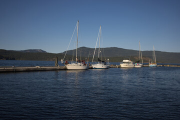 Fototapeta premium Boats docked at the Cowichan Bay Wharf in Cowichan Bay, Vancouver Island, British Columbia, Canada