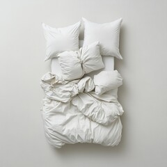 Obraz premium A neatly arranged white bedding set with pillows on a light background.