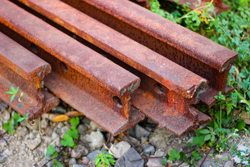 Close-up of a rusty piece of a pile of railroad tracks