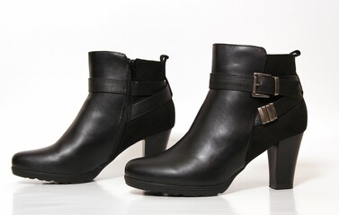 Black leather ankle boots with buckle detail.