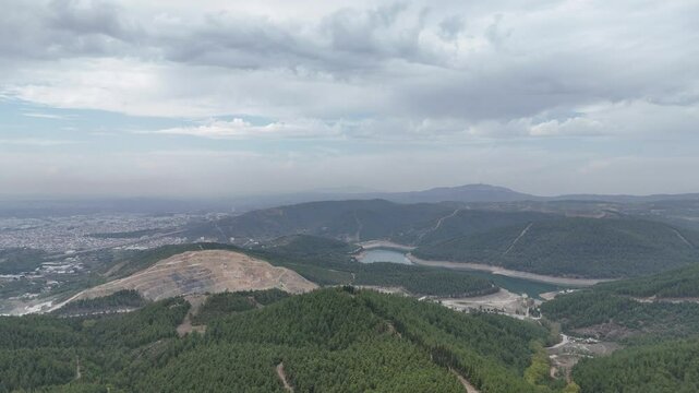 4k Drone video: Misty weather over sky. Lake, forest, landscape and city view.
