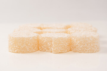 Coconut candy roll isolated on a white background.