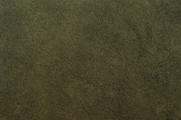 Olive green velour texture, soft fabric surface in close-up, seamless textile pattern.