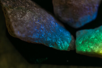 textured raw quartz rocks in green prism light