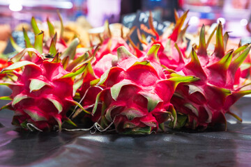 Fresh dragon fruit pitaya on market stall in Valencia, juicy, ripe, and bursting with tropical...