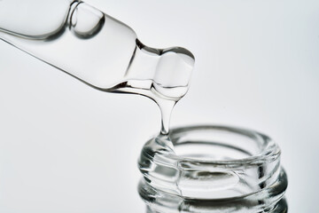 Close-up of a cosmetic bottle with a pipette showing the texture of the serum.