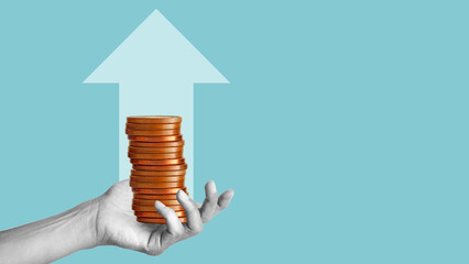 The hand is holding a stack of gold coins and up arrow. Assets and currency trading. Earnings...