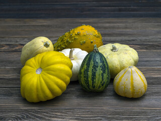 Cucurbita fruits on wooden desk. Close-up