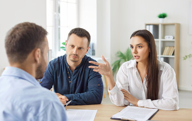 Family couple engages in a briefing and conversation with a real estate consultant or insurance...