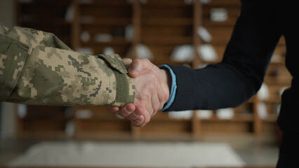 Close up male handshaking. Two unrecognizable men military soldier veteran warrior guy veteran...