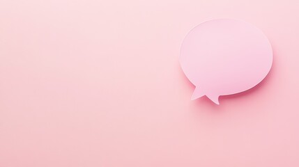 Fototapeta premium A paper speech bubble stands out against a pink background, awaiting words to fill it. 