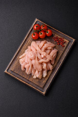 Raw chicken fillet cut into strips with spices and herbs © chernikovatv