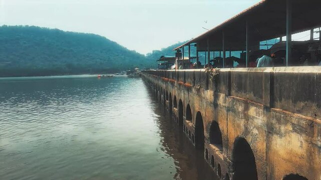 Toy train crossing the bridge at Elephanta Island, Mumbai, India. offering a scenic journey through the lush landscapes of this historic island 4K  