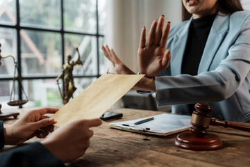 Lawyer refusing bribe from his client at workplace, law and anti corruption concept