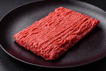 Fresh raw ground beef with salt, spices and herbs