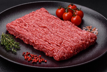 Fresh raw ground beef with salt, spices and herbs