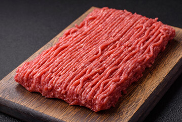 Fresh raw ground beef with salt, spices and herbs