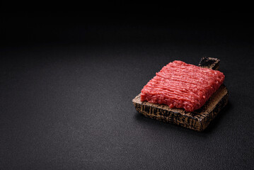 Fresh raw ground beef with salt, spices and herbs